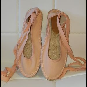 Pink lace up flats.